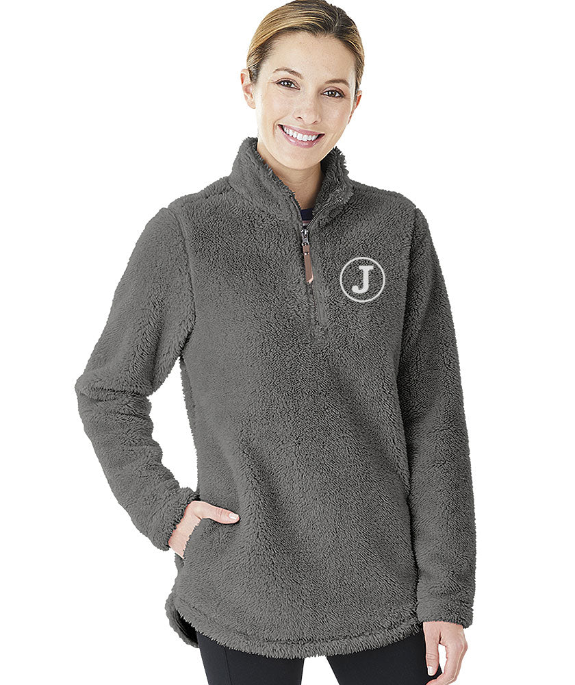 Woman wearing a gray Charles River Newport fleece pullover with a white embroidered 'J' monogram.