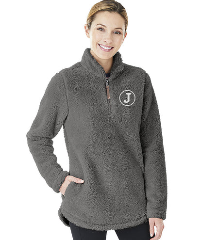 Woman wearing a gray Charles River Newport fleece pullover with a white embroidered 'J' monogram.