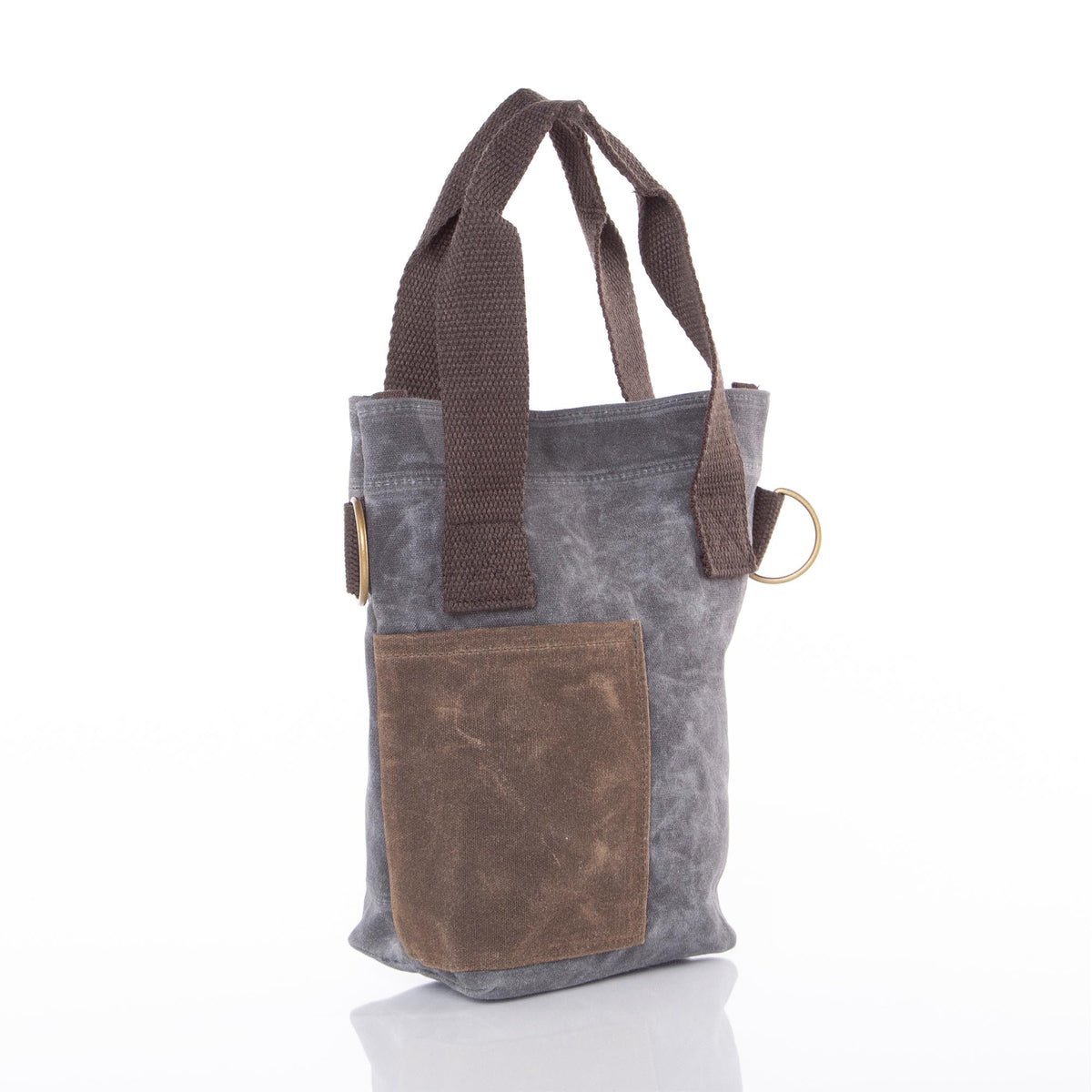 Gray waxed canvas wine bottle tote with brown leather pocket, brown fabric handles, and brass ring detail; no visible monogram or embroidery