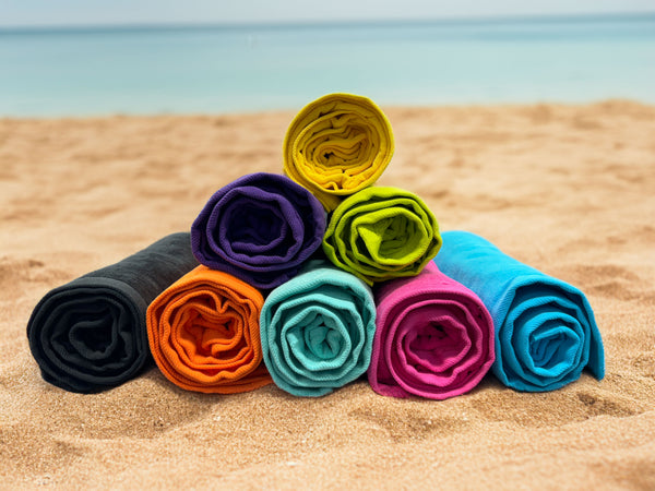 Colorful towels on a beach background