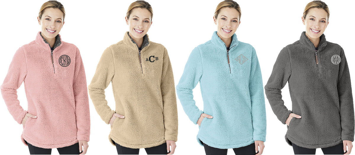 Four women modeling Charles River Newport fleece pullovers in pink, tan, light blue, and gray, each with a monogram.