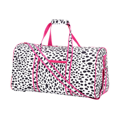 Black and white spotted duffel with pink handles, trim and shoulder strap