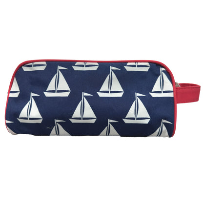 Navy sailboat-print toiletry pouch with red trim and side carry loop