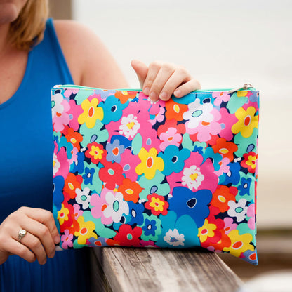 Woman holding a multicolor floral zipper pouch