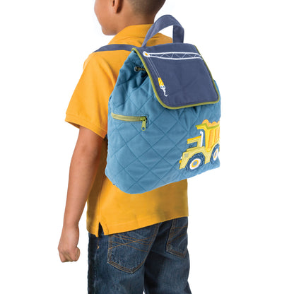Young child wears a quilted blue Stephen Joseph construction backpack with yellow dump truck embroidery and a crane graphic on the front pocket