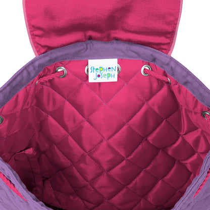 Open quilted backpack interior in magenta with purple trim, showing white Stephen Joseph brand label stitched inside the diamond-quilted lining