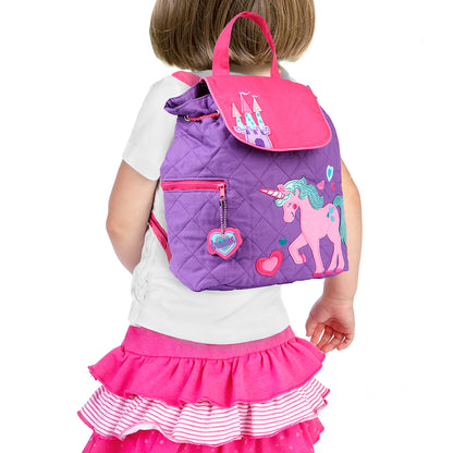 Toddler wears purple quilted Stephen Joseph unicorn backpack with pink castle flap, embroidered unicorn print, and heart zipper pull