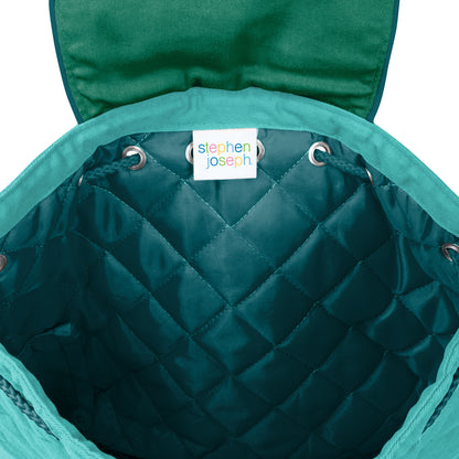 Open teal quilted Stephen Joseph toddler backpack showing diamond-stitched interior lining and white brand label with colorful logo sewn inside