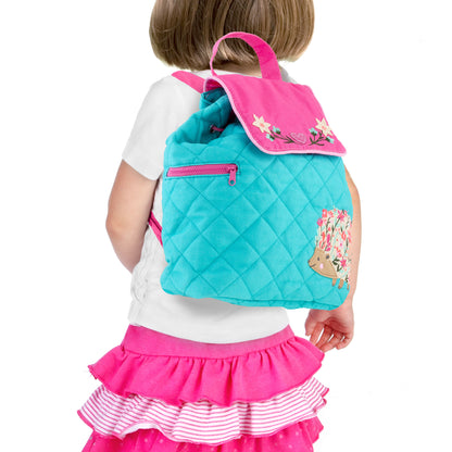 Toddler wearing turquoise quilted backpack with pink flap, floral embroidery, and embroidered hedgehog design on Stephen Joseph backpack