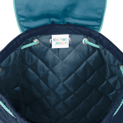 Inside view of navy quilted Stephen Joseph toddler backpack with teal drawstrings and white brand label at top opening