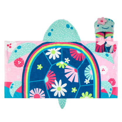 Laid flat, this hooded towel features a blue floral turtle shell, pink background, and a matching rolled towel with a pink bo