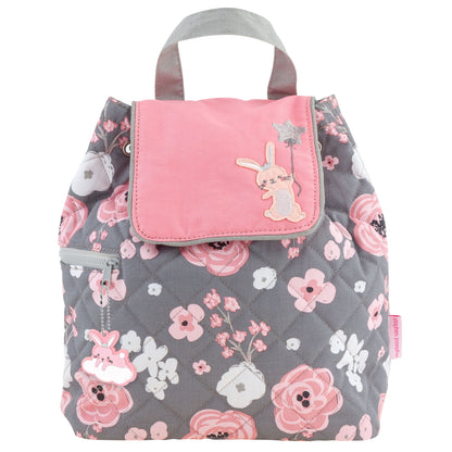 Gray quilted backpack with pink and white floral print, pink flap, bunny appliqué, handles, and side zipper.