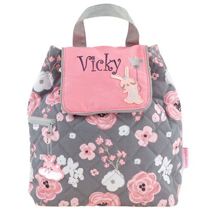 Gray quilted floral backpack with pink flap, embroidered bunny, star balloon, side zipper, and “Vicky” name.