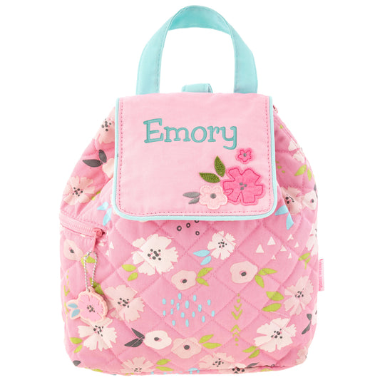 Pink quilted floral backpack with aqua handles, personalized flap, flower appliqués and side zipper.