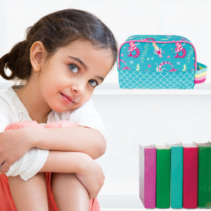Teal toiletry bag with pink mermaids and a scale pattern, displayed on a shelf next to a young girl.