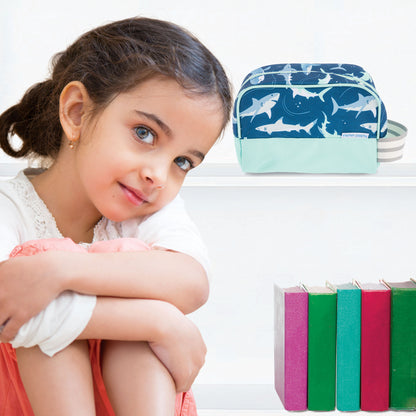 Dark blue toiletry bag with shark pattern and mint green base, displayed on a shelf next to a young girl.