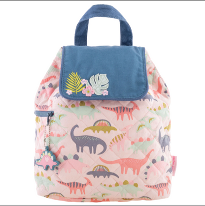 Pink quilted Stephen Joseph backpack with colorful dinosaur print, blue flap featuring embroidered tropical leaves and flowers, top handle and side pocket