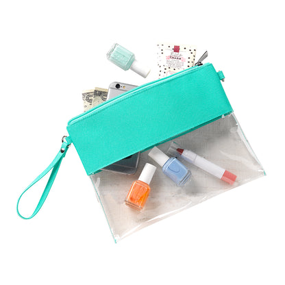 Clear bag with mint trim, flat view beside cosmetics