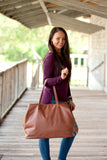 woman with camel cambridge travel bags 