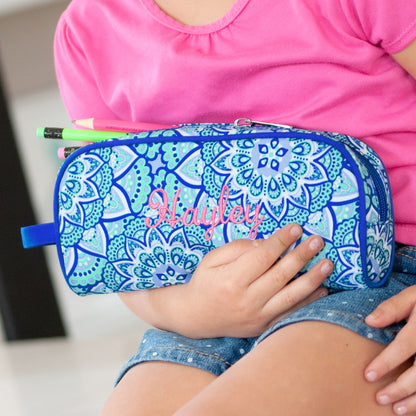 Close-up of embroidered Hayley personalization on a blue mandala pencil case held in a child's lap