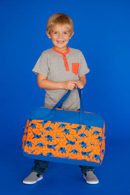 Child holding an orange dinosaur-print travel bag