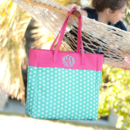 Child carrying a mint polka-dot tote with pink top panel