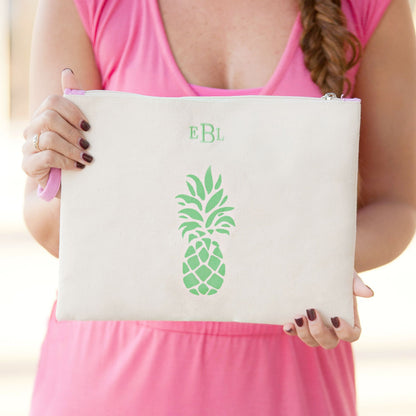 Pineapple pouch with green initials held at the waist