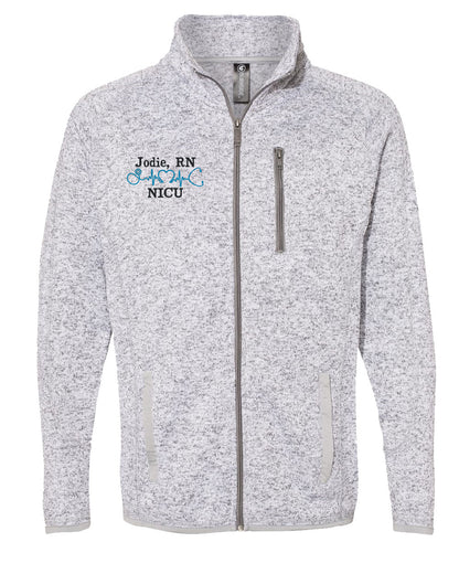 Heather gray zip-up sweater knit jacket with embroidered 'Jodie, RN NICU' and blue stethoscope design.