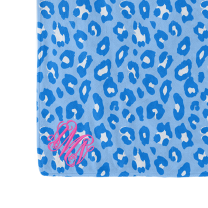Blue leopard-print blanket with pink monogram detail
