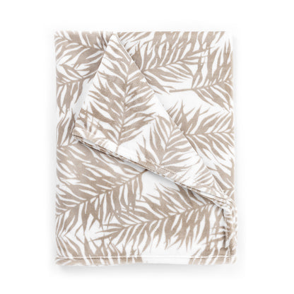 Folded beige palm-leaf-print blanket