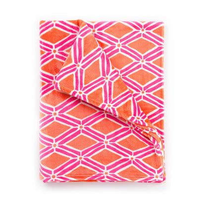 Folded pink and orange geometric-print blanket