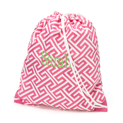 Pink and white geometric drawstring bag with a monogram