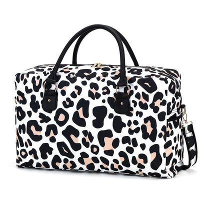White duffel with black and brown leopard spots and black handles