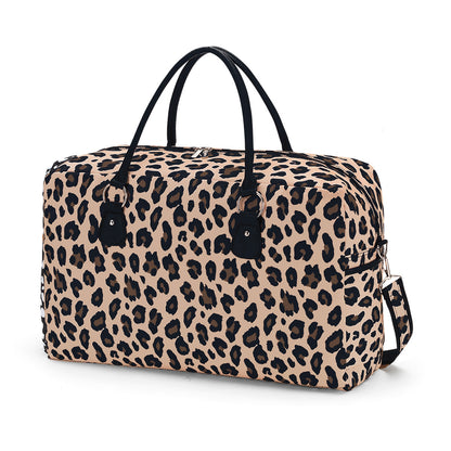 Tan leopard-print duffel with black handles on a white background