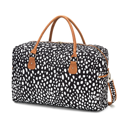 Black duffel with irregular white spots and tan handles