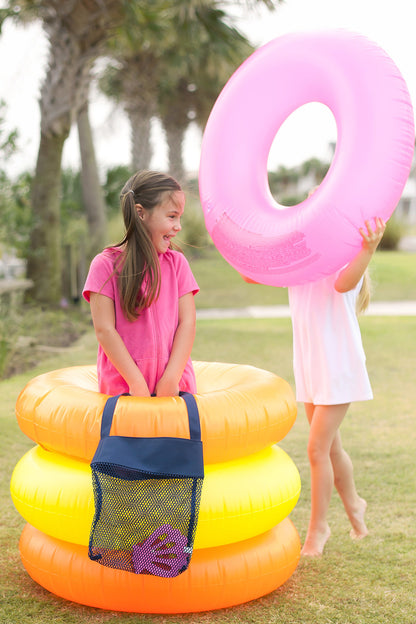 Navy mesh tote beside children holding pool floats