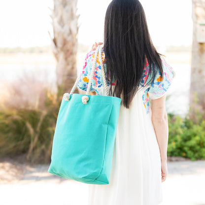 Mint rope-handle tote worn over the shoulder outdoors