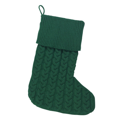 Hunter green cable knit Christmas stocking with folded ribbed cuff on white