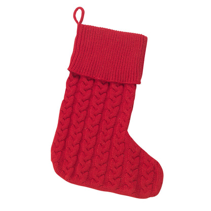 Red cable knit Christmas stocking with folded ribbed cuff on white