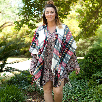 Woman wearing a multicolor plaid shawl outdoors