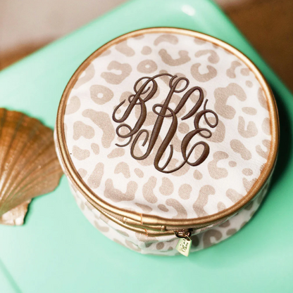 Cream leopard-print jewelry case with a brown monogram