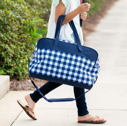 Navy checked travel bag carried by a child outdoors