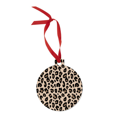 Round tan and black leopard print ornament with red hanging ribbon