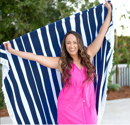Woman holding a navy and white striped beach blanket