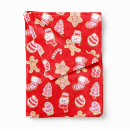 Folded red blanket with gingerbread and holiday treat print