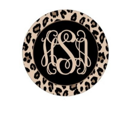Tan and black leopard print ornament with a beige three letter monogram in the black center