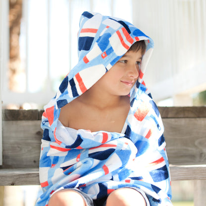 Child wearing an Oh Buoy hooded towel with red and blue buoy print