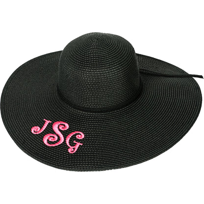 Black floppy hat with a pink monogram on the brim