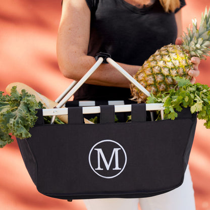 Black market basket with a white initial filled with produce