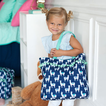Navy llama tote with mint handles carried by a child